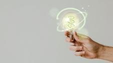Green Energy With Hand Holding Environmental Light Bulb Background