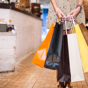 Woman-holding-bunch-paper-bags